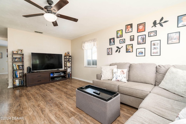 living room featuring ceiling fan and wood-type flooring