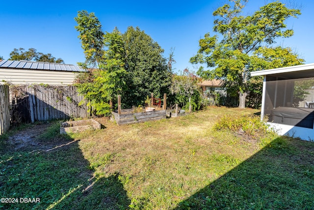 view of yard featuring a sunroom