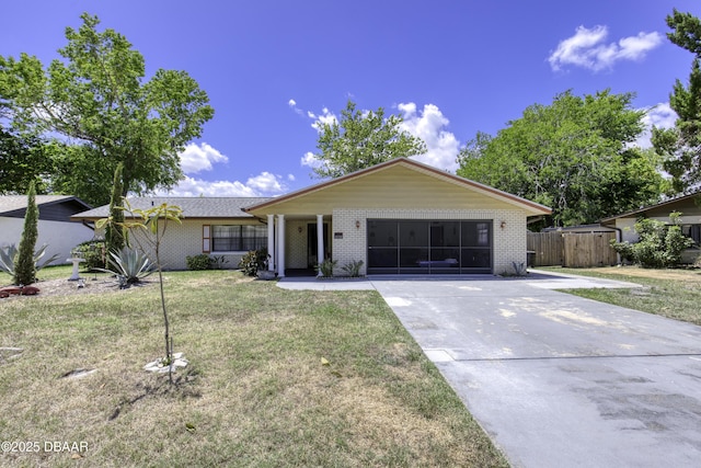 1970 Red Cedar Cir S, Daytona, FL 32119 - ranch-style house featuring fence, driveway, brick siding, and a front yard