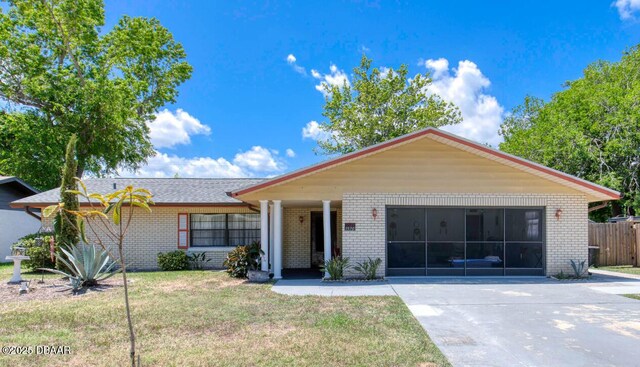 1970 Red Cedar Cir S, Daytona, FL 32119 - ranch-style home with brick siding, driveway, and an attached garage