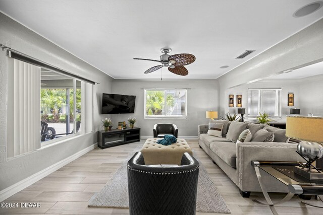 living room featuring ceiling fan and light hardwood / wood-style floors