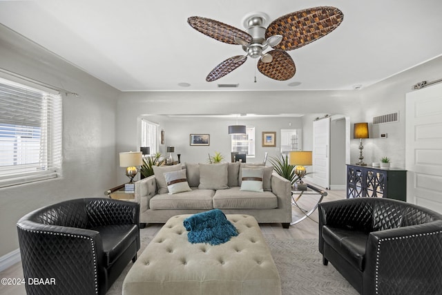 living room featuring light wood-type flooring and ceiling fan