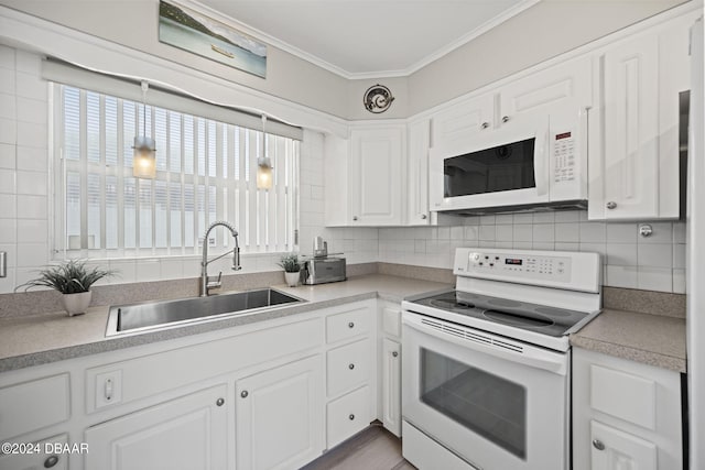 kitchen featuring white cabinetry, ornamental molding, sink, and white appliances