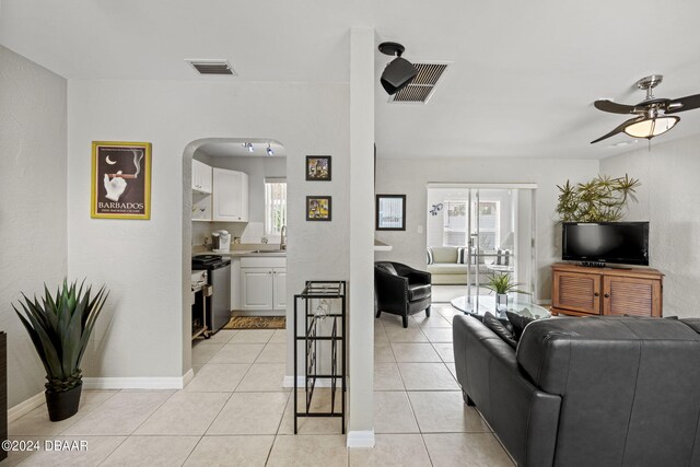 tiled living room with sink and ceiling fan