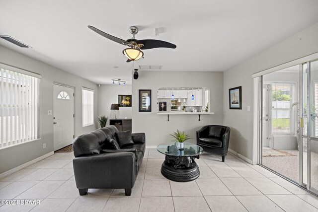 living room with light tile patterned floors and ceiling fan