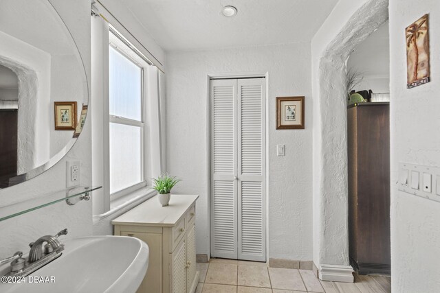 bathroom with a healthy amount of sunlight, sink, and tile patterned floors