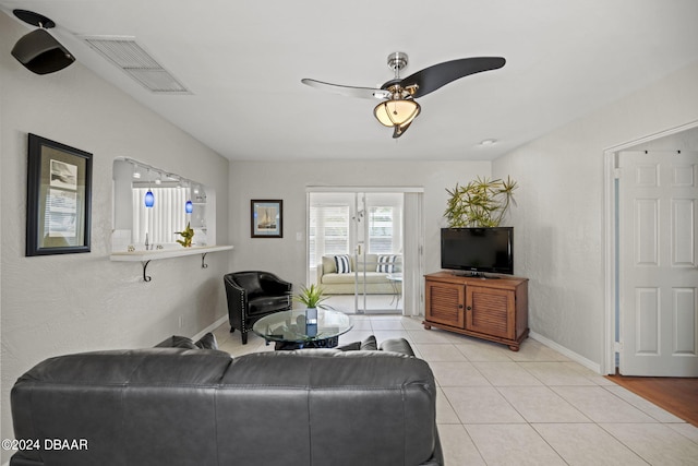 living room with light tile patterned floors and ceiling fan