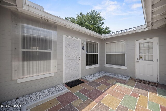 doorway to property featuring a patio