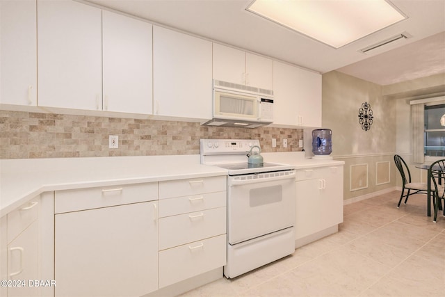 kitchen featuring backsplash, white cabinetry, white appliances, and light tile patterned floors