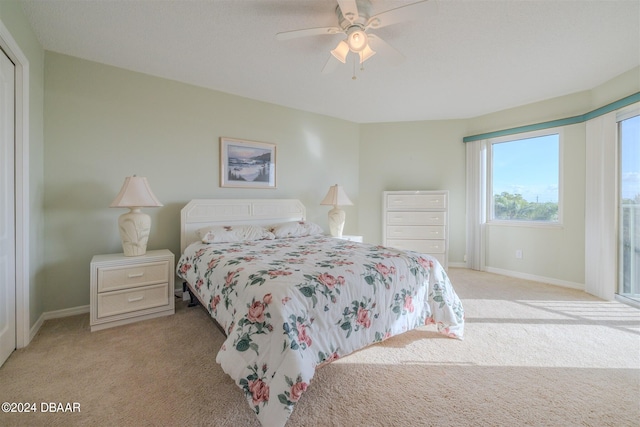 bedroom featuring ceiling fan and light colored carpet