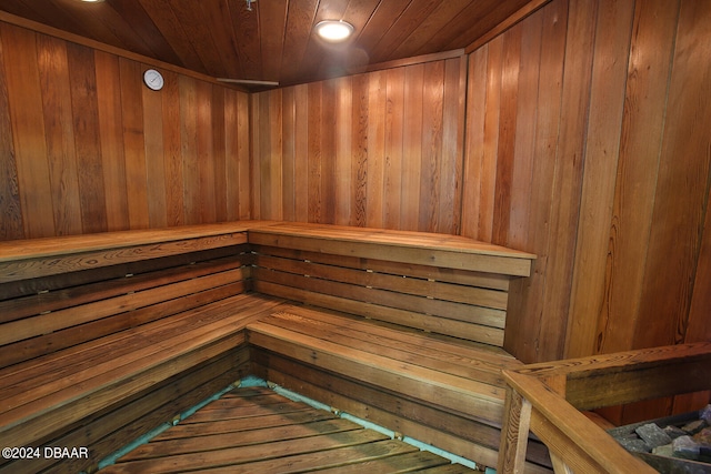 view of sauna / steam room featuring wooden walls and wood ceiling