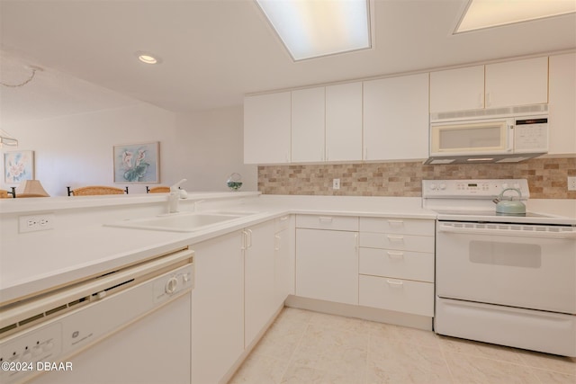 kitchen with white cabinetry, light tile patterned floors, decorative backsplash, sink, and white appliances