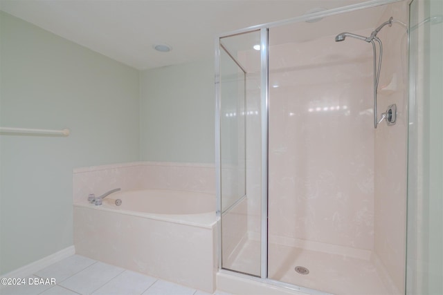 4 Oceans W Blvd Unit 407B, Daytona Beach Shores, FL 32118 - bathroom featuring tile patterned flooring, a shower stall, a garden tub, and baseboards
