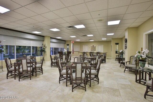 dining area with a paneled ceiling