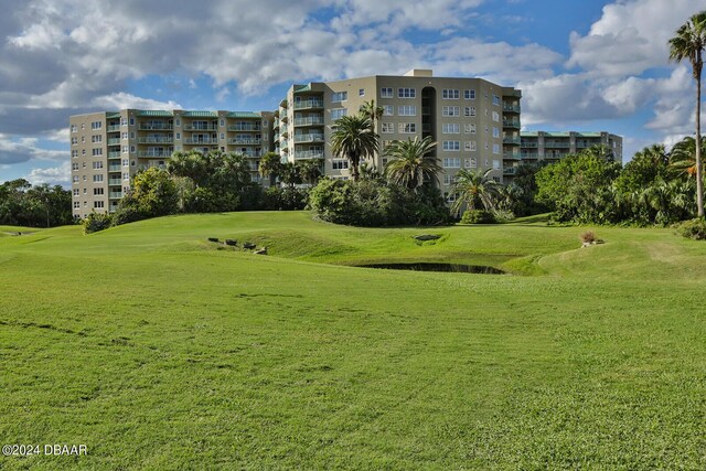 4 Oceans W Blvd Unit 407B, Daytona Beach Shores, FL 32118 - view of property's community featuring view of golf course, a yard, and a water view