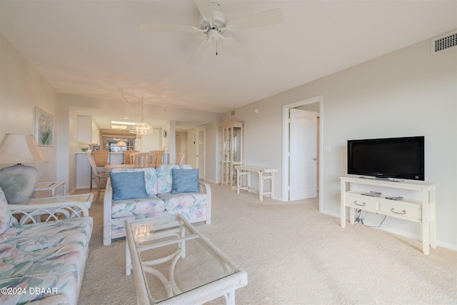 carpeted living room with ceiling fan