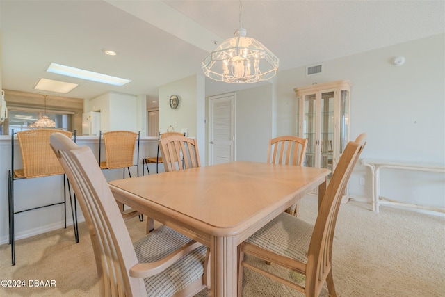 dining space featuring a notable chandelier and light carpet