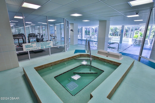 view of swimming pool featuring an indoor hot tub