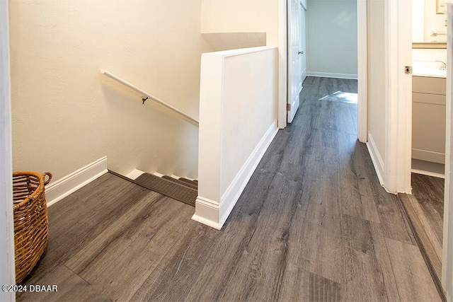 corridor with dark hardwood / wood-style flooring