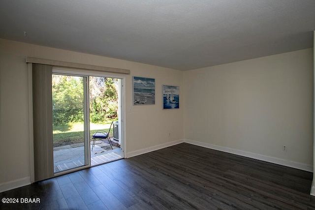 empty room with dark hardwood / wood-style flooring