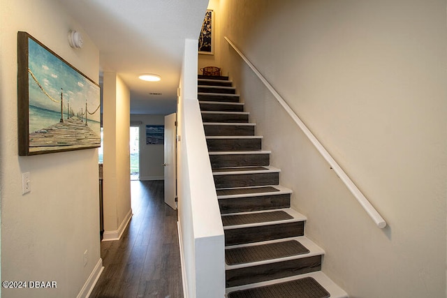 stairway with hardwood / wood-style flooring