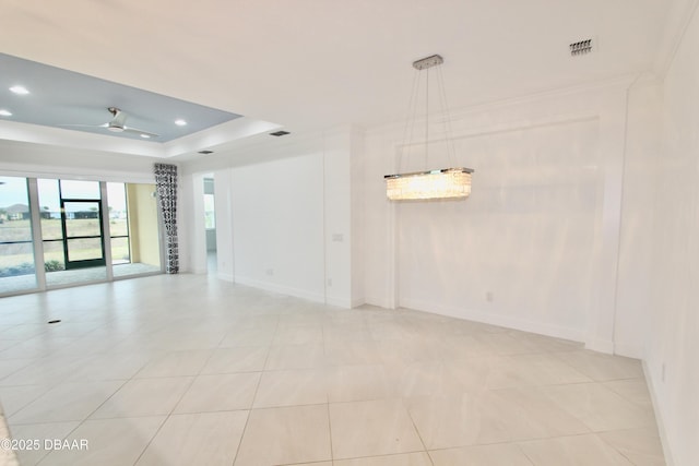 unfurnished room featuring ceiling fan, a tray ceiling, crown molding, and light tile patterned flooring