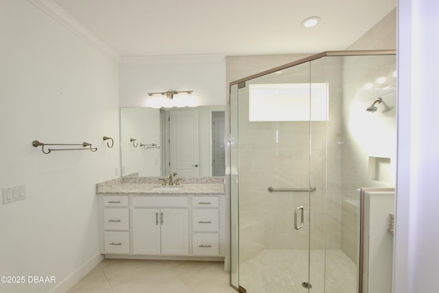 bathroom with a shower with shower door, vanity, ornamental molding, and tile patterned flooring