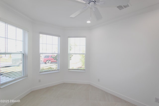 tiled empty room featuring ceiling fan, plenty of natural light, and ornamental molding