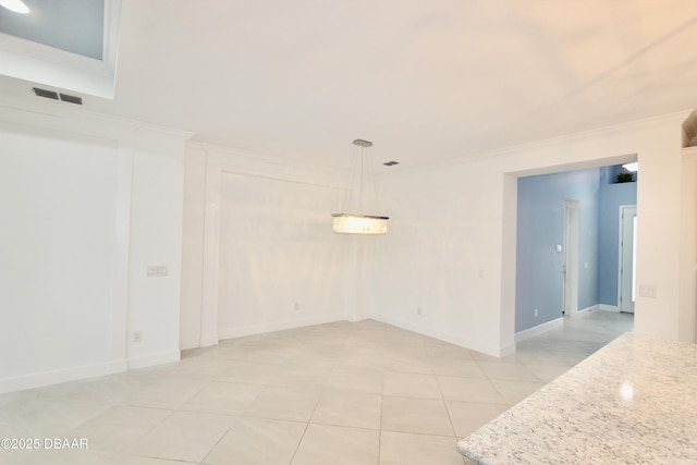 spare room with light tile patterned flooring and crown molding