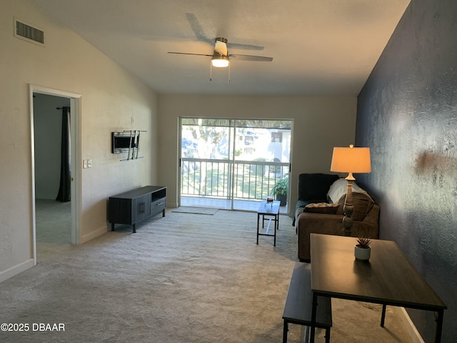 carpeted living room featuring lofted ceiling and ceiling fan