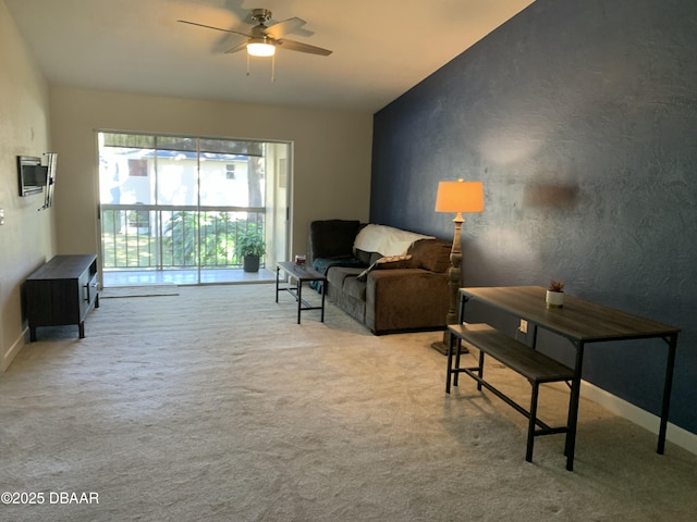 carpeted living room featuring ceiling fan