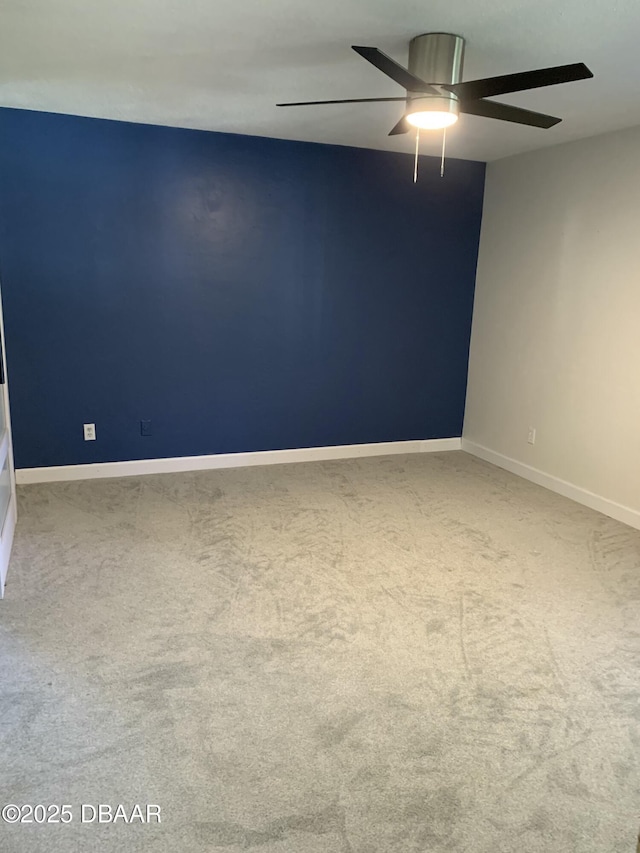 unfurnished room with ceiling fan and carpet floors