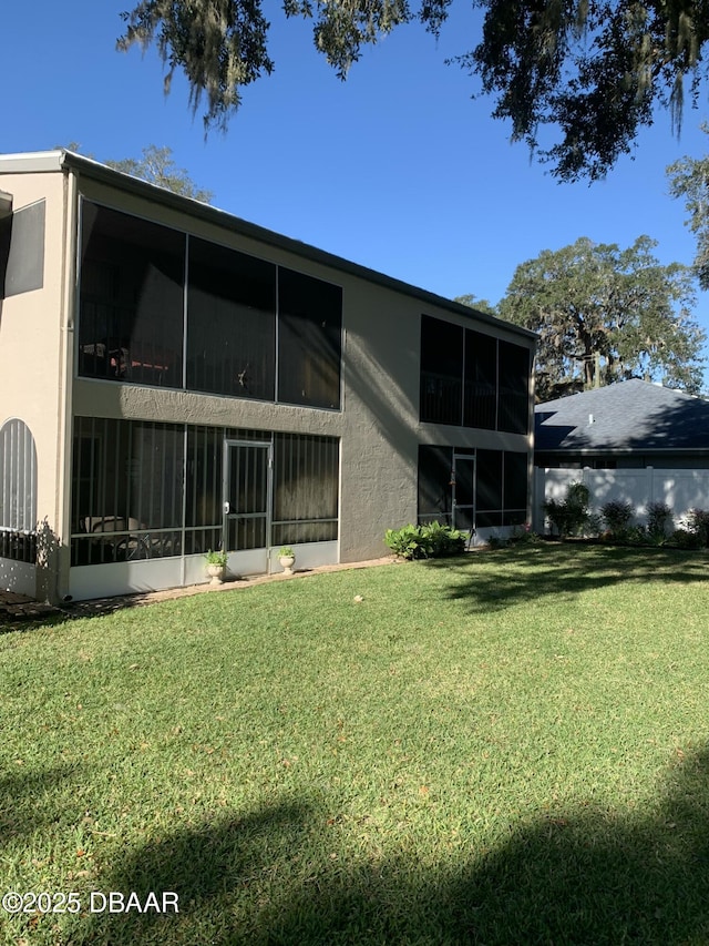 rear view of property featuring a yard