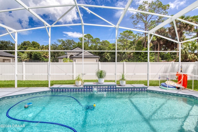 view of pool featuring glass enclosure