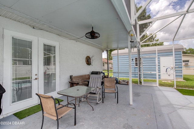 view of patio featuring glass enclosure and ceiling fan