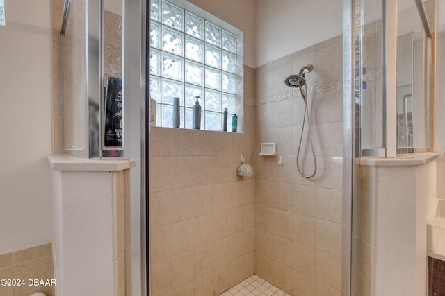 bathroom with tiled shower