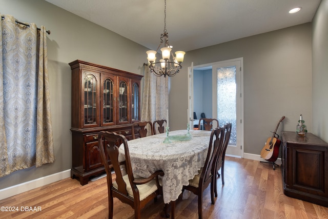 dining room featuring light hardwood / wood-style floors and a chandelier