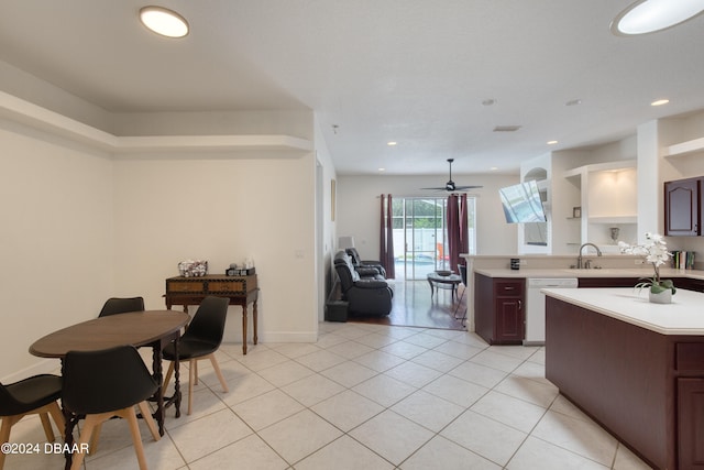 kitchen with sink, kitchen peninsula, white dishwasher, ceiling fan, and light tile patterned floors