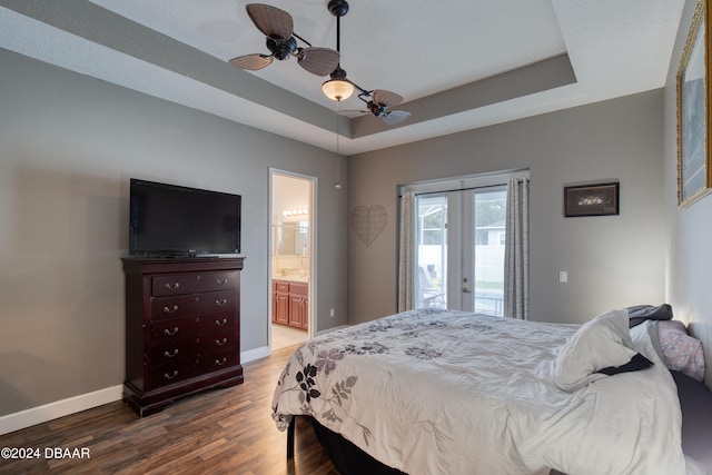 bedroom with access to outside, a raised ceiling, hardwood / wood-style floors, ceiling fan, and ensuite bathroom