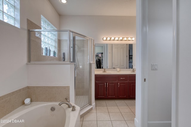 bathroom featuring independent shower and bath, vanity, and tile patterned floors