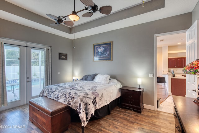 bedroom featuring access to outside, hardwood / wood-style floors, ceiling fan, and french doors