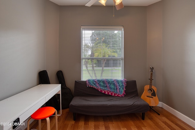 sitting room with wood-type flooring and ceiling fan