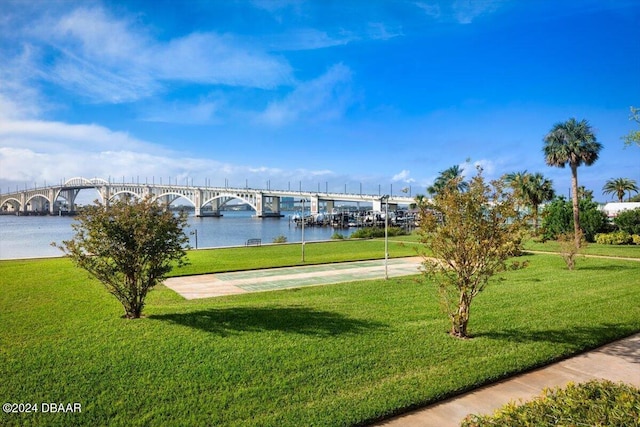 dock area with a water view and a yard