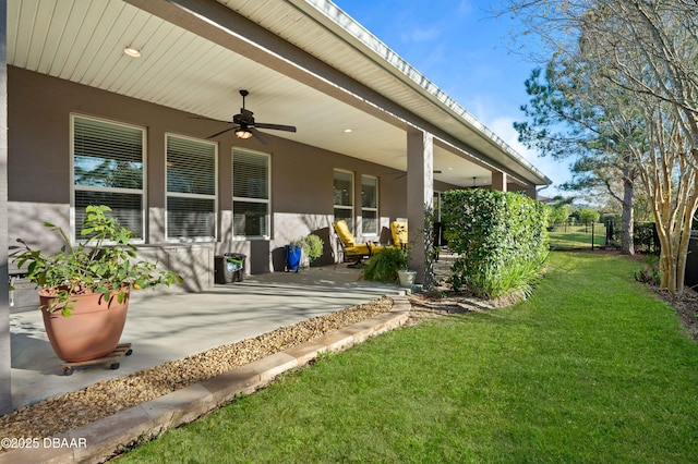 view of yard featuring a patio area and ceiling fan