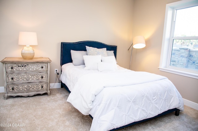 carpeted bedroom featuring baseboards