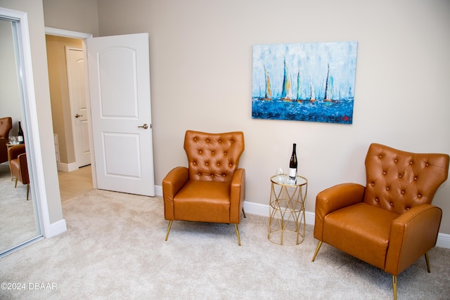 sitting room featuring baseboards and carpet floors