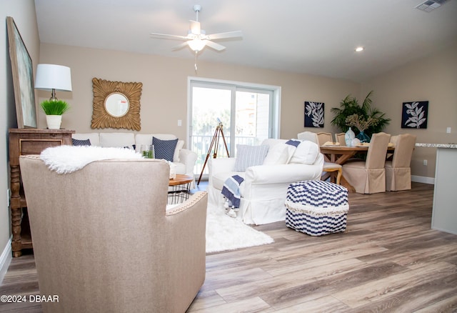 living room with wood finished floors, recessed lighting, baseboards, ceiling fan, and vaulted ceiling