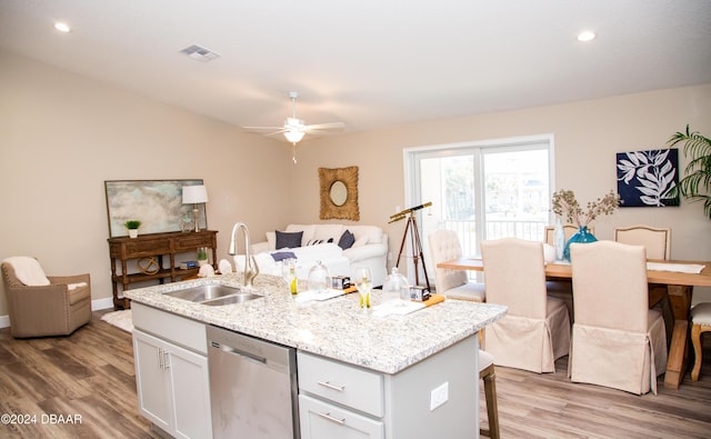 kitchen with visible vents, light wood-style flooring, a sink, open floor plan, and dishwasher