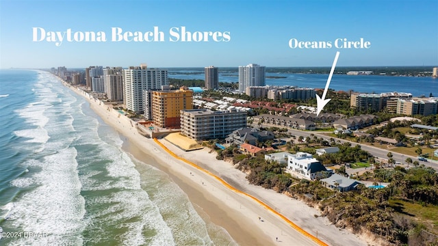 birds eye view of property with a view of city, a beach view, and a water view