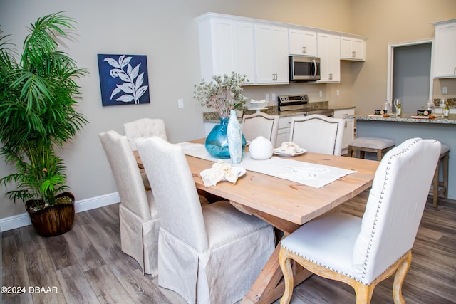 dining area featuring wood finished floors and baseboards